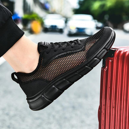 Stevvex men's black sneakers with breathable mesh upper and cushioned sole on foot on Tampa Home & Garden Store