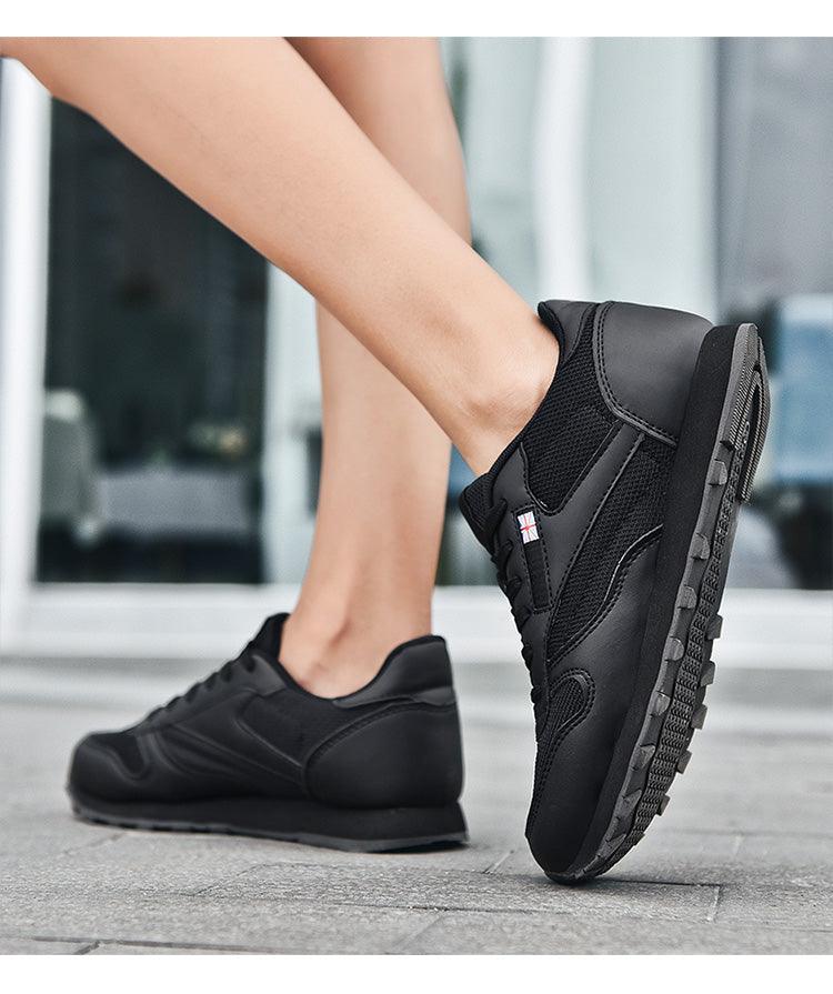 Black lace-up sneakers with mesh upper and leather-like overlays, pair on Tampa Home & Garden Store