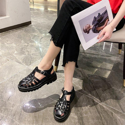 Pair of Stevvex black platform sandals with open toe, woven straps, thick sole on Tampa Home & Garden Store