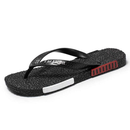 Men's black Stevvex flip flop sandal with textured pebble sole and red side accent on Tampa Home & Garden Store