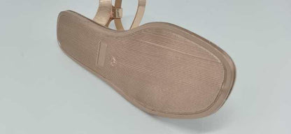 Beige flat sandal with ankle strap and buckle, bottom sole view showing textured outsole on Tampa Home & Garden Store