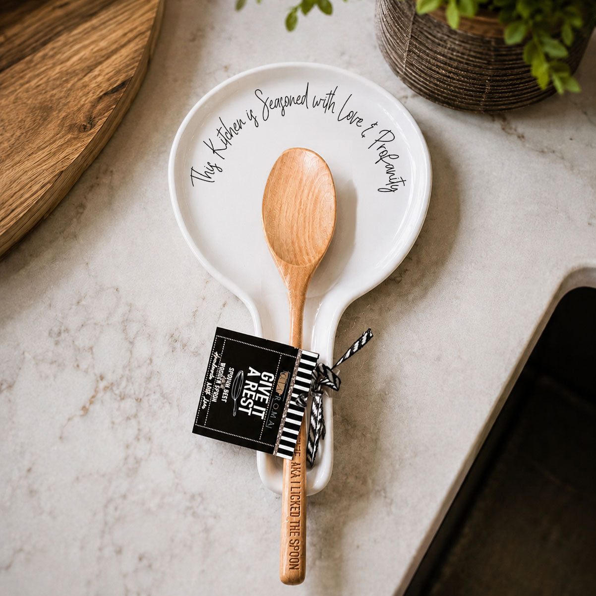 Gia Roma Love & Profanity spoon rest, white ceramic plate with black script and a wooden spoon on Tampa Home & Garden Store
