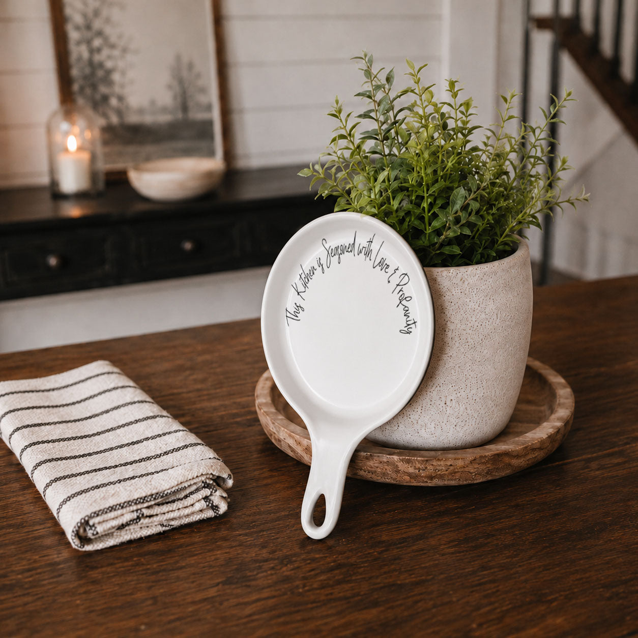 Spoon rest Love & Profanity by Gia Roma, white ceramic with black script on a wooden table on Tampa Home & Garden Store