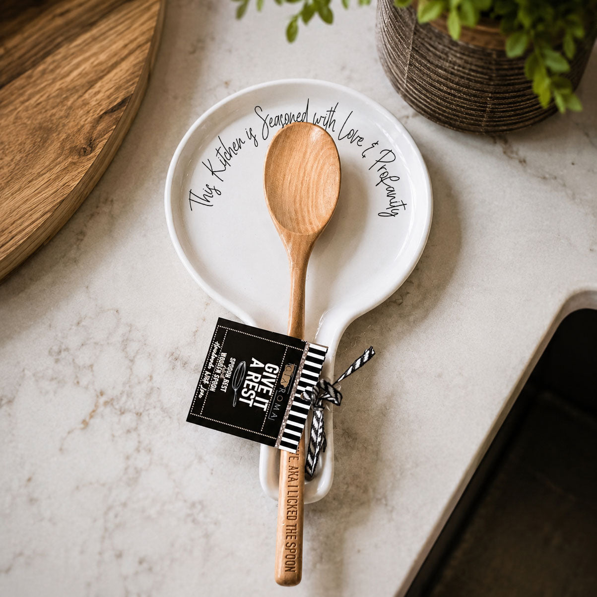 Love & Profanity spoon rest Gia Roma; white ceramic plate with wooden spoon and tag on Tampa Home & Garden Store