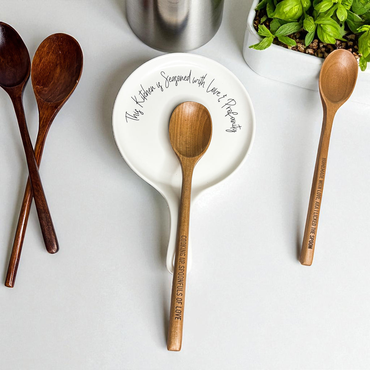 Love & Profanity spoon rest by Gia Roma; white ceramic plate with quote amid wooden spoons on Tampa Home & Garden Store