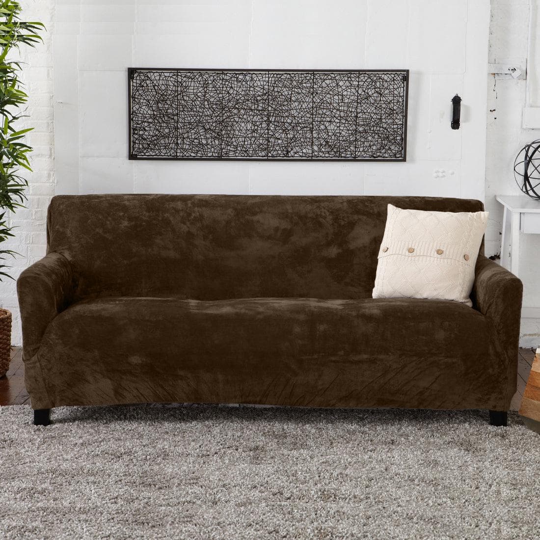 Velvet stretch slipcover Gale Collection Great Bay Home on brown sofa with beige pillow on Tampa Home & Garden Store