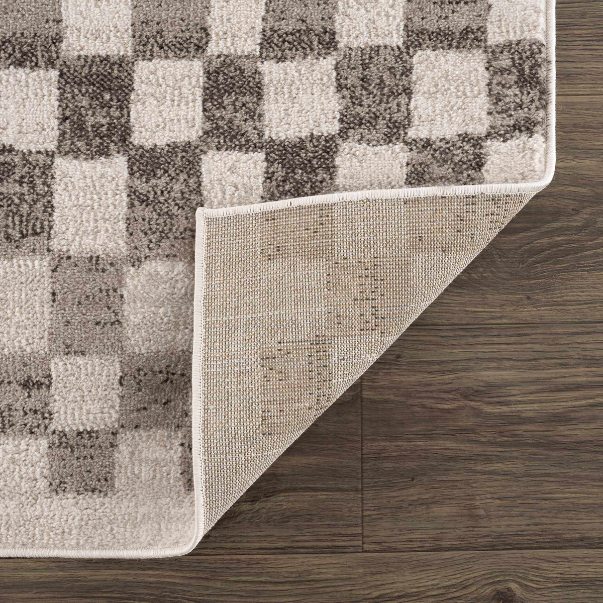 Benjy irregular checkboard rug beige and brown pattern Boutique Rugs on wood floor on Tampa Home & Garden Store