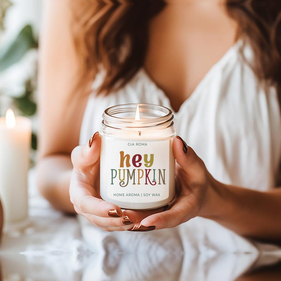 Baked Pumpkin Candle by Gia Roma in a glass jar with colorful Hey Pumpkin label, held by hands on Tampa Home & Garden Store