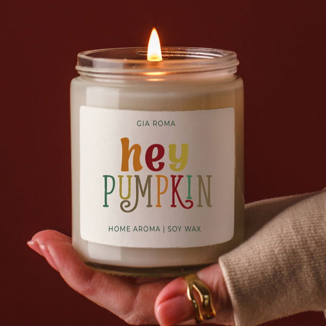 Baked Pumpkin Candle by Gia Roma in a clear glass jar with a lit flame and multicolor label on Tampa Home & Garden Store