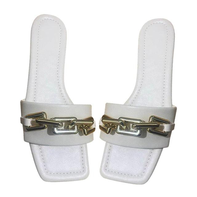 White leather slide sandals with a gold chain across the strap, pair on Tampa Home & Garden Store