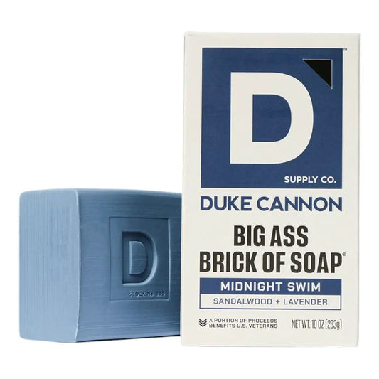 Big Ass Brick of Soap Midnight Swim blue soap with D imprint beside the Duke Cannon box sandalwood on Tampa Home & Garden Store