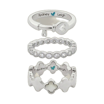 Set of 3 Sydney Leigh rings in silver tones: heart key charm, pavé band, and clover motif on Tampa Home & Garden Store
