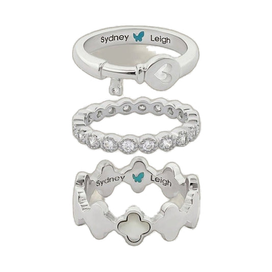 Set of 3 Sydney Leigh rings in silver tones: heart key charm, pavé band, and clover motif on Tampa Home & Garden Store