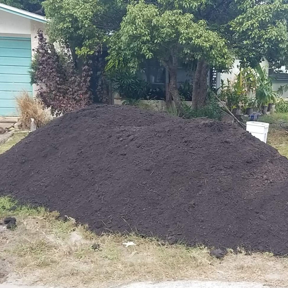 Mulch and soil delivery in separate piles. Soil pile shown.