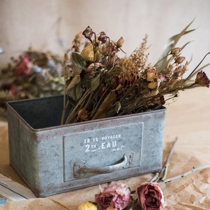 Rectangular iron planter drawer in weathered galvanized metal, holding dried flowers on Tampa Home & Garden Store