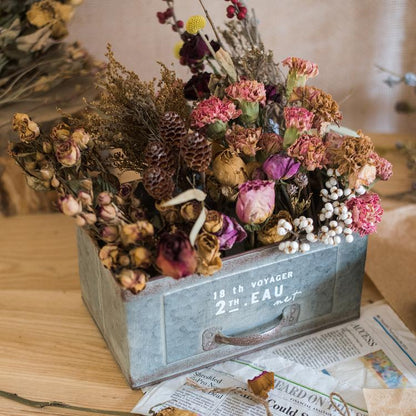 Rectangular iron planter drawer in galvanized gray, filled with dried pink blooms and pinecones on Tampa Home & Garden Store