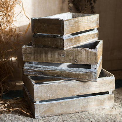 Rectangular solid wood crates, weathered gray-brown, stacked in a five-crate display on Tampa Home & Garden Store