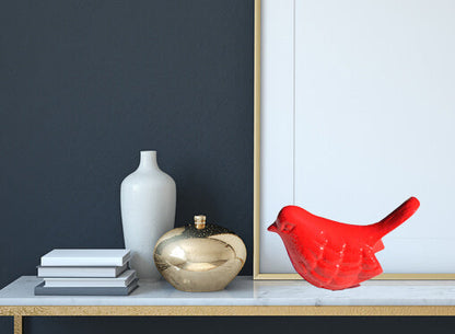 Vibhsa red bird figurine on a shelf with decorative vases and books on Tampa Home & Garden Store