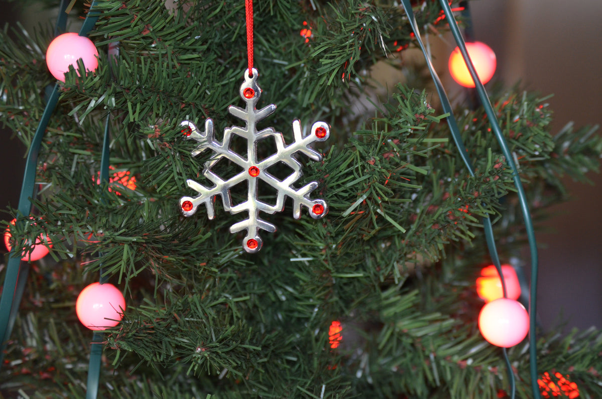 Vibhsa snowflake ornament handmade in silver with red rhinestones on Christmas tree on Tampa Home & Garden Store