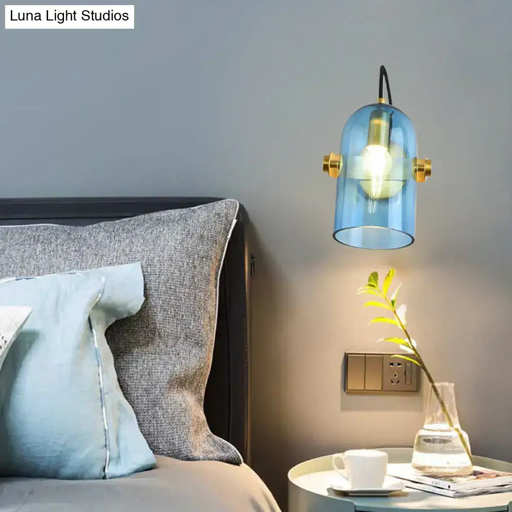 Brass cloche sconce light by Decorbites with blue glass shade, wall mounted beside bed on Tampa Home & Garden Store