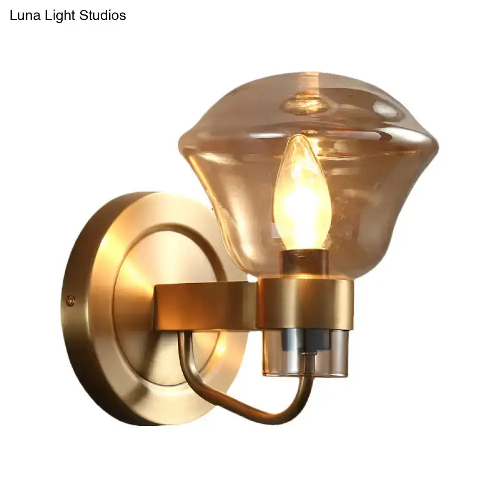 Retro brass wall sconce with smoke gray amber glass shade and curved arm for bedroom decor on Tampa Home & Garden Store