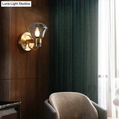 Retro brass wall sconce with amber glass shade and smoky gray accents by Decorbites on Tampa Home & Garden Store