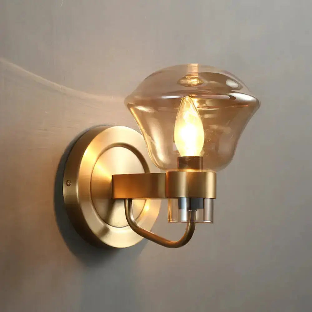 Retro brass wall sconce with smoke gray and amber glass shade, curved arm, round backplate on Tampa Home & Garden Store