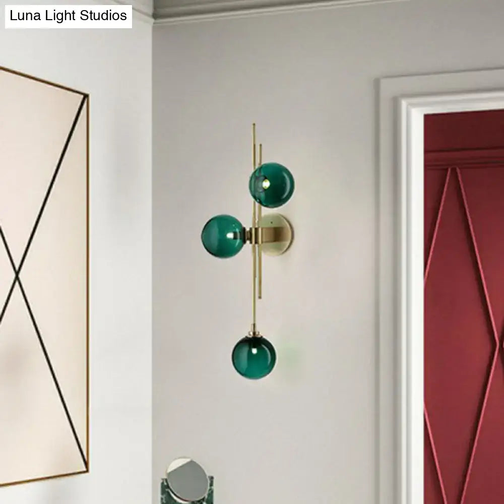 Brass triple globe sconce with emerald glass by Decorbites on Tampa Home & Garden Store