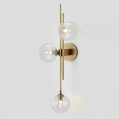 Brass triple globe wall sconce with three clear glass globes and round wall mount Decorbites on Tampa Home & Garden Store
