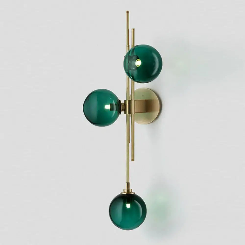 Brass triple globe sconce by Decorbites with emerald green glass globes, wall-mounted on Tampa Home & Garden Store