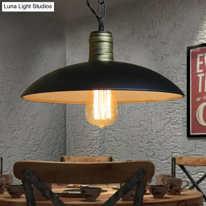 Black brass ceiling light with wide matte shade and warm Edison bulb over a dining table on Tampa Home & Garden Store