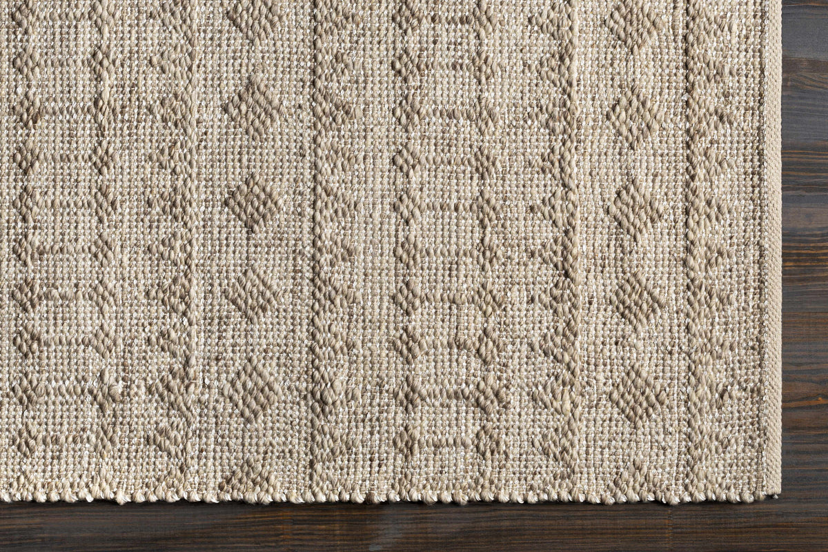 Argonne Area Rug natural beige jute with diamond motif and braided border on wood floor on Tampa Home & Garden Store