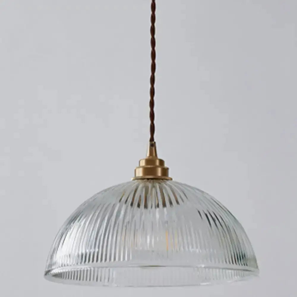Ribbed glass pendant light with brass cap and brown cord in dining room on Tampa Home & Garden Store