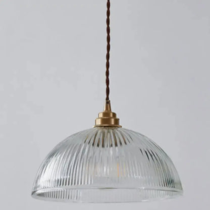 Ribbed glass pendant light with brass cap and brown cord in dining room on Tampa Home & Garden Store