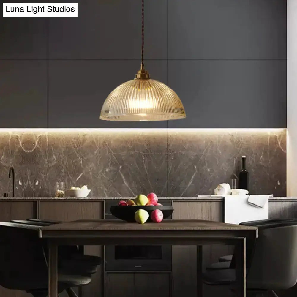 Ribbed glass brass pendant light for dining room by Decorbites over a dark wooden dining table on Tampa Home & Garden Store
