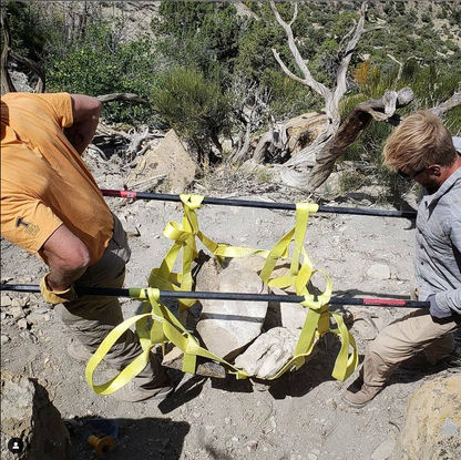 Rock Hammock by Backslope Tools with yellow straps securing a rocky ledge in rugged terrain on Tampa Home & Garden Store
