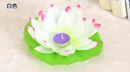 Lotus floating candle with white petals tipped pink on a green leaf, purple center LED tealight on Tampa Home & Garden Store