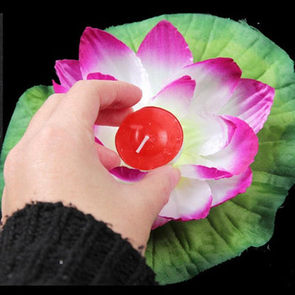 Floating lotus candle red flameless LED held over a pink-white lotus leaf by Stevvex on Tampa Home & Garden Store