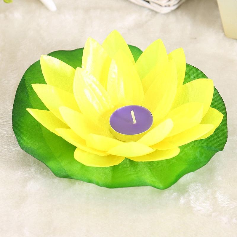 Floating lotus candle with yellow petals on green leaf base, purple tealight on Tampa Home & Garden Store