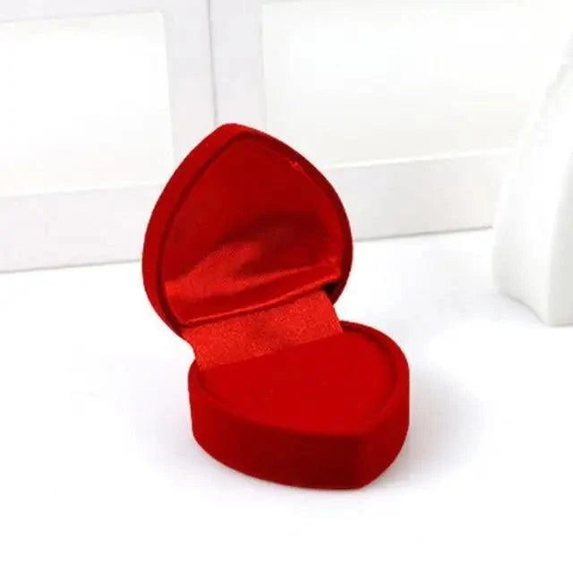 Red heart-shaped velvet jewelry box with satin lining open on Tampa Home & Garden Store