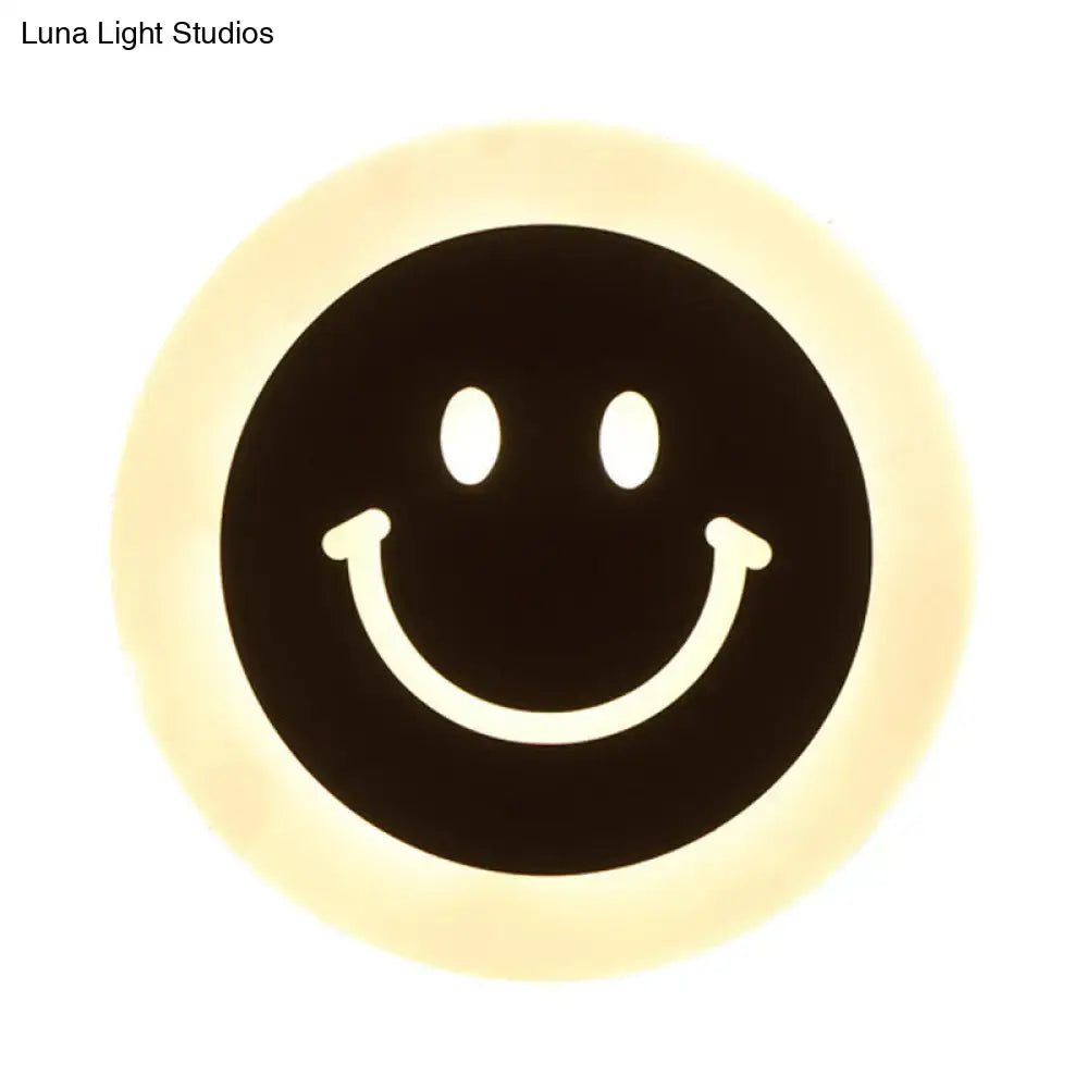 LED Round Wall Sconce black circular face with a white smile and warm halo glow on Tampa Home & Garden Store