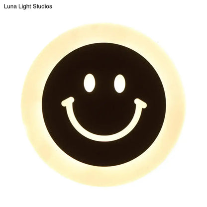 LED Round Wall Sconce black circular face with a white smile and warm halo glow on Tampa Home & Garden Store