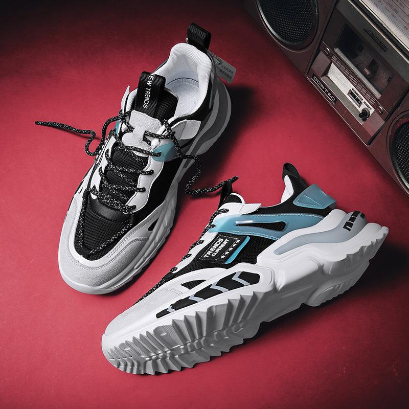 Stevvex running sneakers, black and white with blue accents, pair on red backdrop on Tampa Home & Garden Store