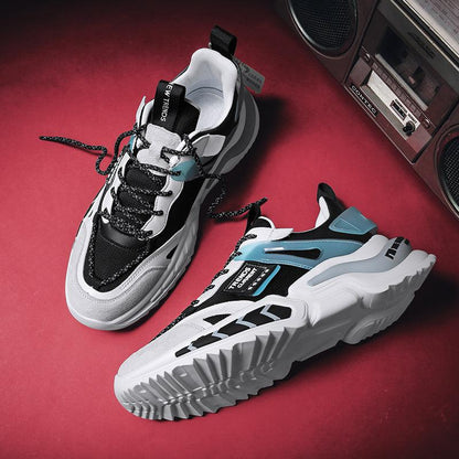 Stevvex running sneakers, black and white with blue accents, pair on red backdrop on Tampa Home & Garden Store