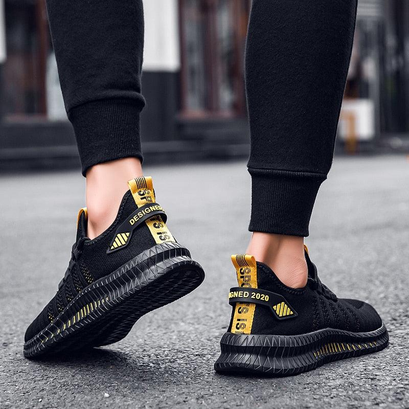 Stevvex pair of breathable men's athletic sneakers with black upper yellow pull tabs non-slip sole on Tampa Home & Garden Store