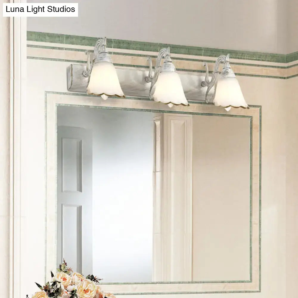 White glass vanity light Decorbites with three frosted shades above a bathroom mirror on Tampa Home & Garden Store
