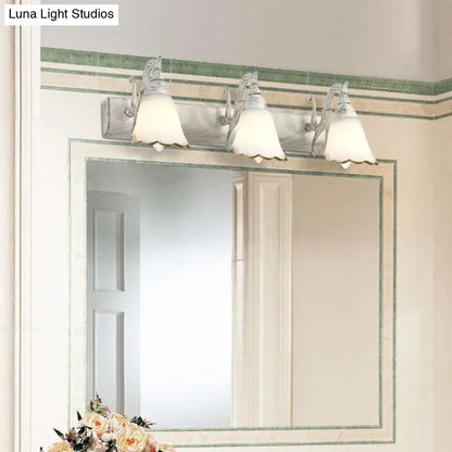 White glass vanity light Decorbites with three frosted shades above a bathroom mirror on Tampa Home & Garden Store