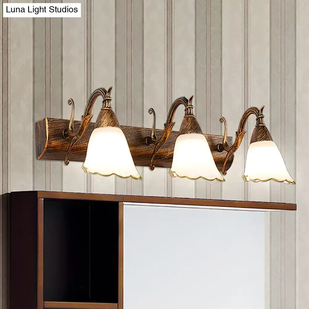 White glass vanity light by Decorbites with four bell shades on bronze arms above backplate on Tampa Home & Garden Store