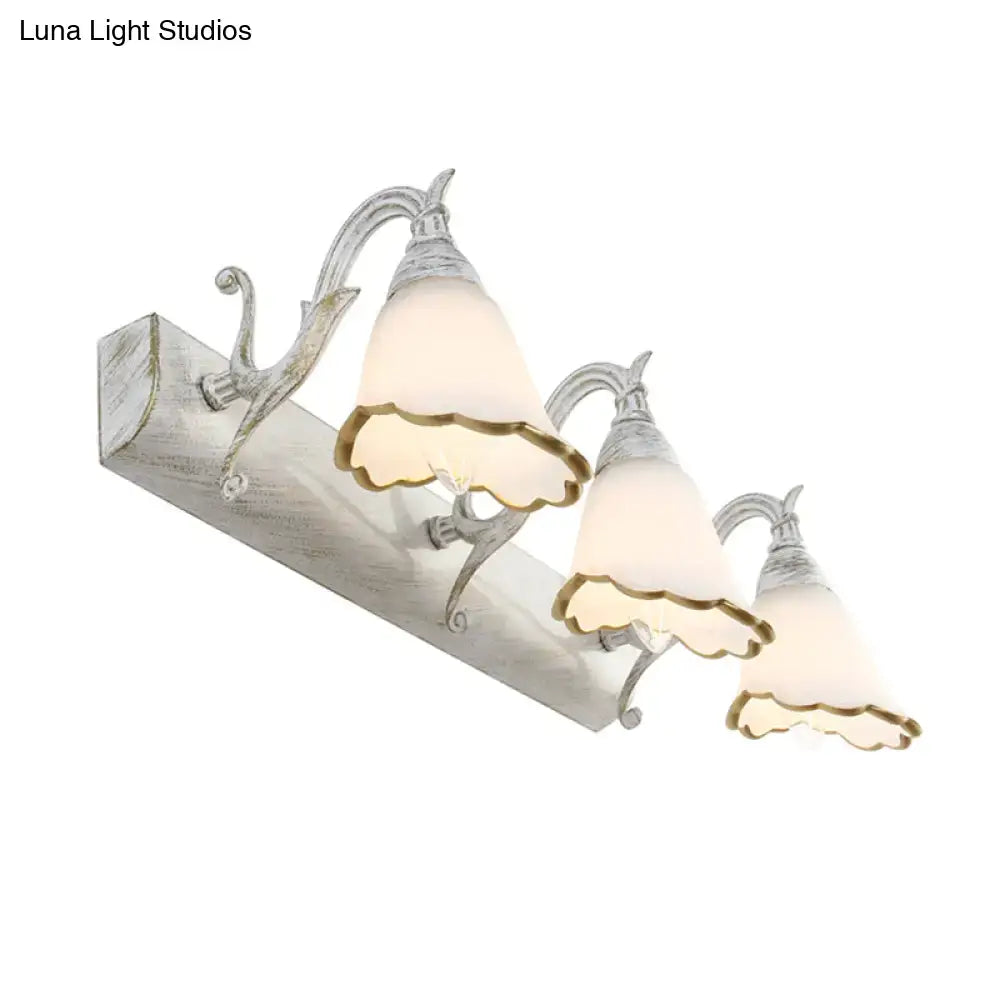 White glass vanity light with ornate metal scroll arms, 3-light fixture by Decorbites on Tampa Home & Garden Store