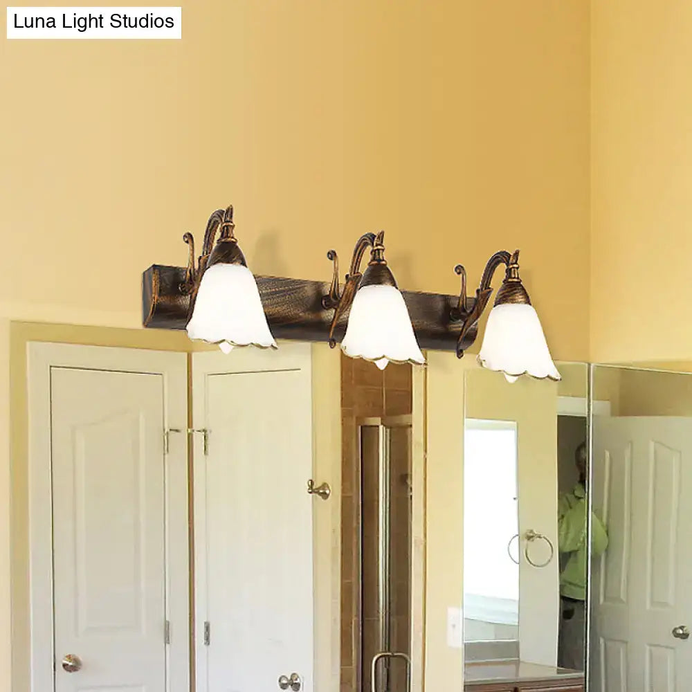 White Glass Vanity Light by Decorbites with three bell shades on a dark bronze bar on Tampa Home & Garden Store